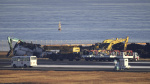 Japanese safety experts search for voice data as workers clear plane debris from runway collision The Associated Press Japanese safety experts search for voice data as workers clear plane debris from runway collision The Associated Press